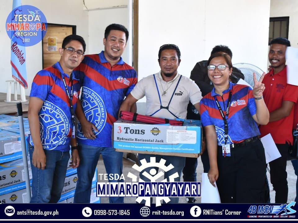 TESDA graduates receiving or holding their starter toolkits